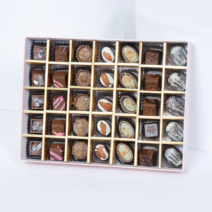 شوكولاتة إمباير: علبة شوكولاتة وردية فاخرة تحتوي على 35 قطعة مختارة و باقة ورود أنيقة