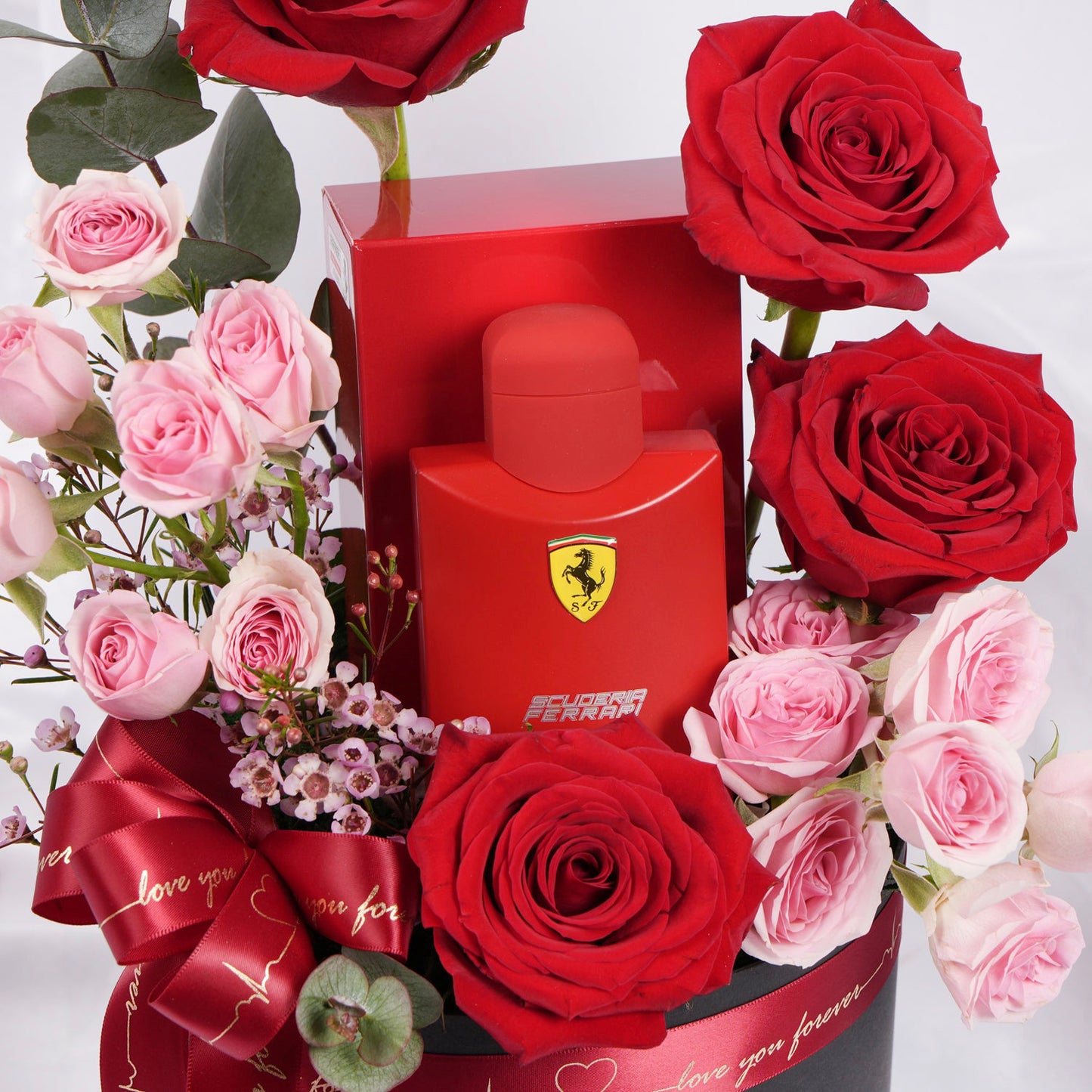 Elegant Ferrari Red Perfume Gift Set with Luxurious Floral Arrangement