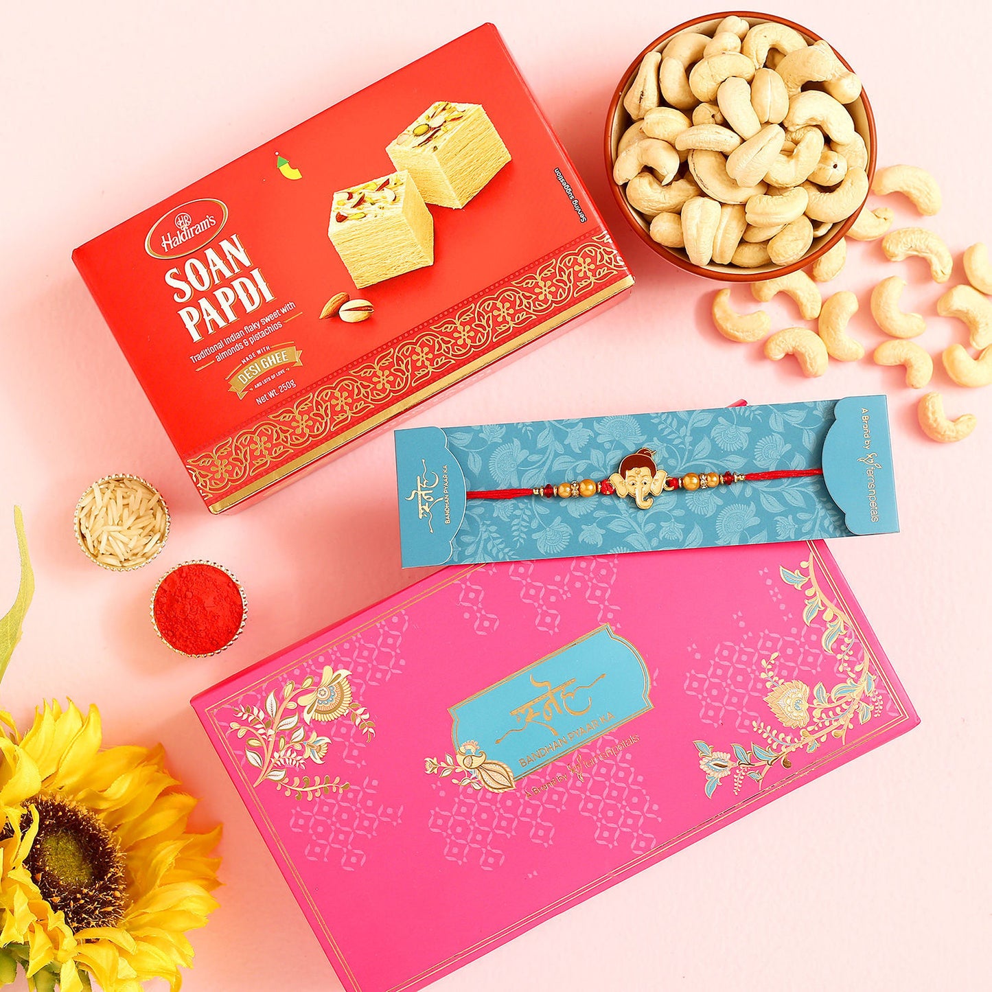Ganesha Face Kids Rakhi Gift Set with Cashew Nuts and Soan Papdi