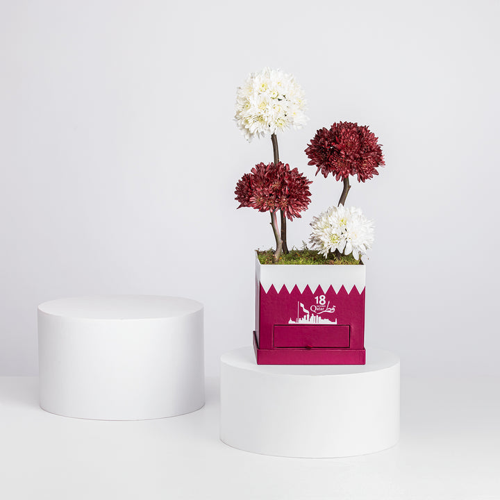 تنسيق زهور الأقحوان الأنيق لليوم الوطني مع شوكولاتة