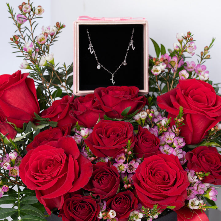 ورود حمراء رومانسية مع عقد حب فضي فاخر