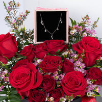 ورود حمراء رومانسية مع عقد حب فضي فاخر