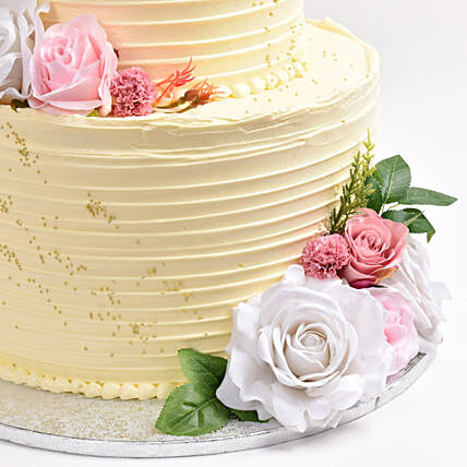 Elegant Three-Tier Wedding Cake with Floral Accents