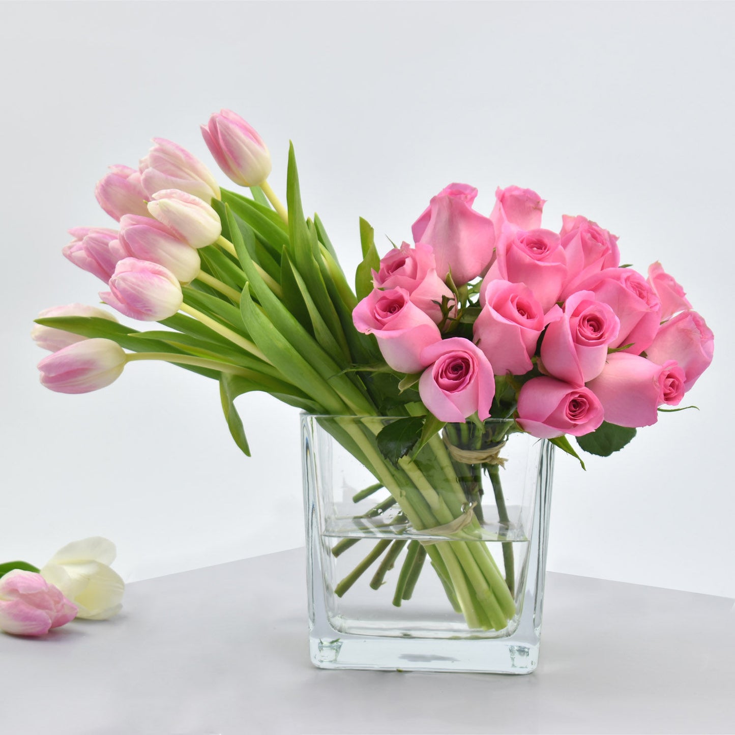Elegant Pink Roses and Tulips Arrangement in a Glass Vase