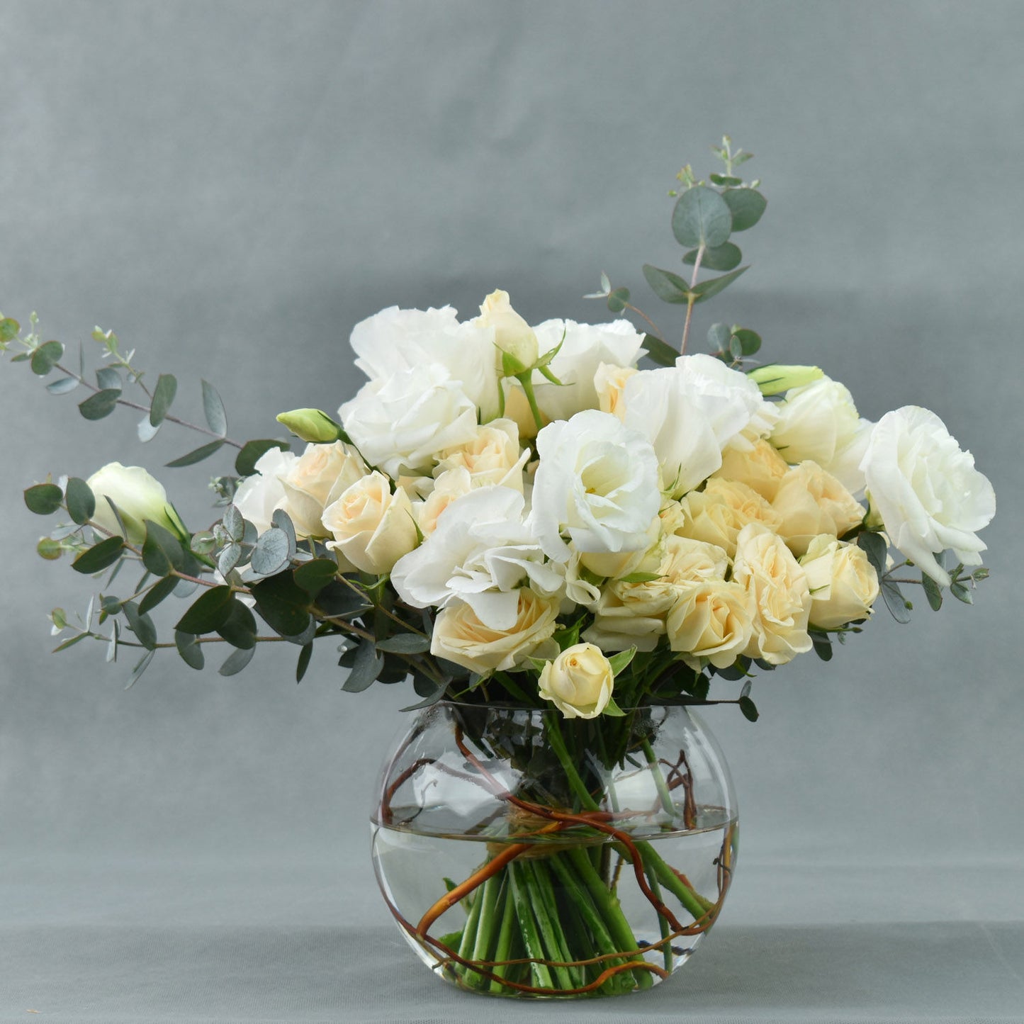 Elegant Fish Bowl Arrangement with Peach Spray Roses and White Lisianthus