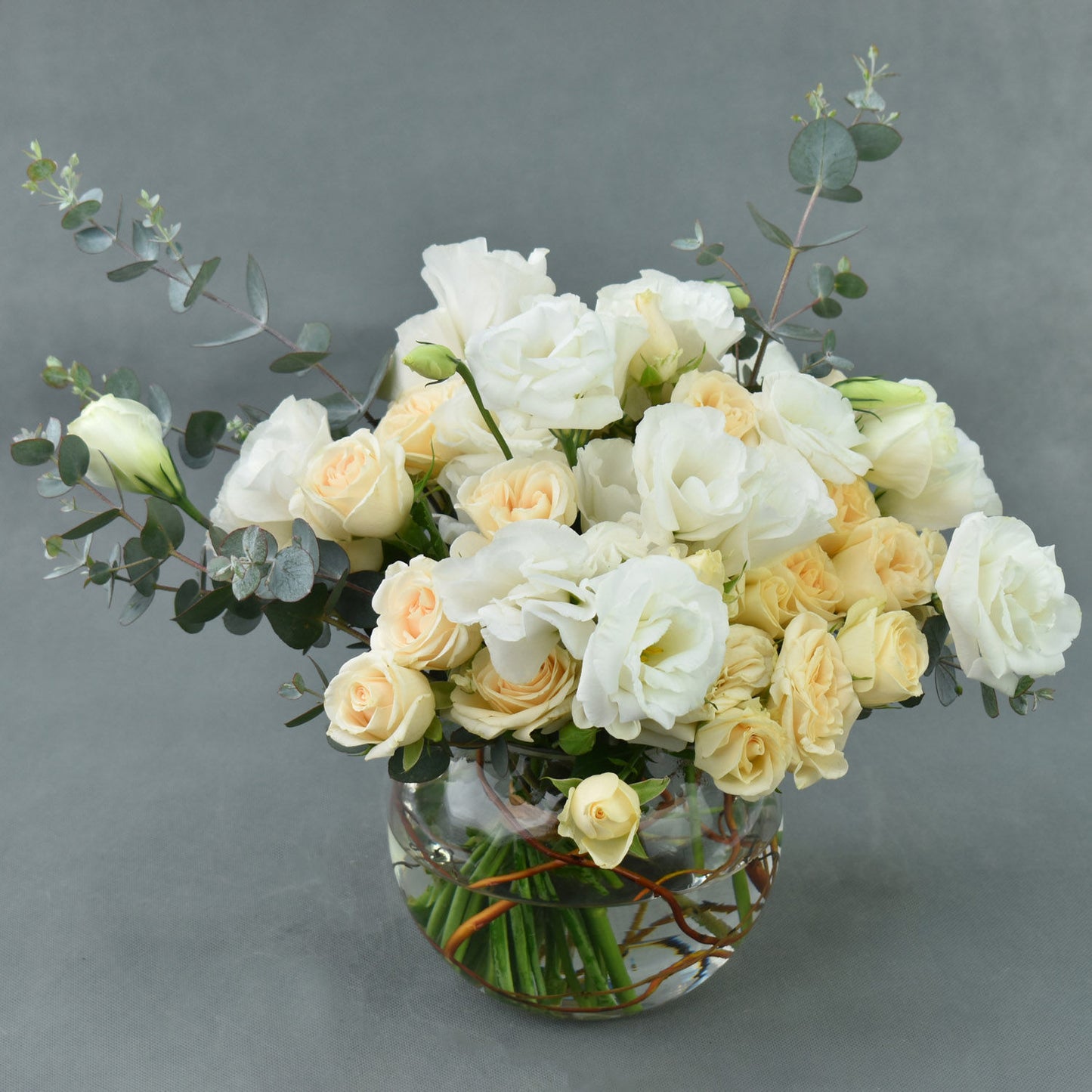 Elegant Fish Bowl Arrangement with Peach Spray Roses and White Lisianthus