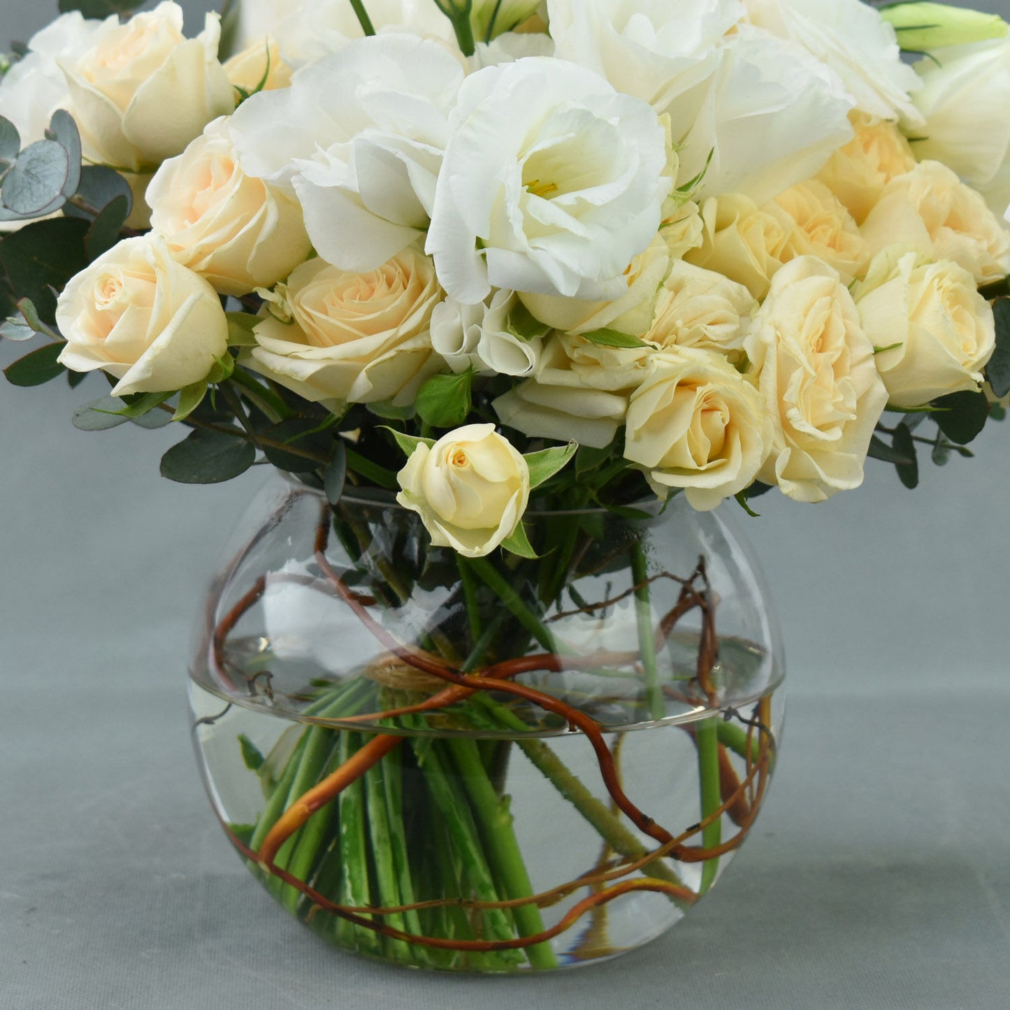 Elegant Fish Bowl Arrangement with Peach Spray Roses and White Lisianthus