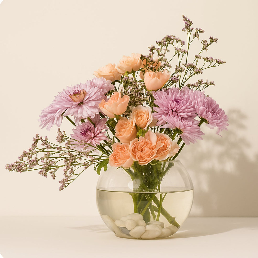 Radiant Femme Sphere: Elegant Floral Arrangement in Fish Bowl