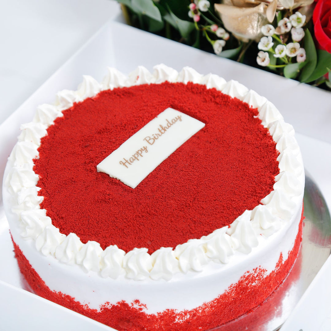 Birthday Bliss: Luxurious Red Velvet Cake with Elegant Floral Arrangement