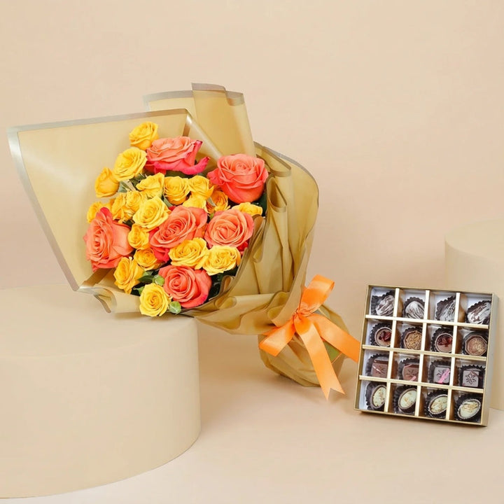علبة شوكولاتة ذهبية فاخرة مع 16 قطعة متنوعة وباقة زهور يدوية مبهجة
