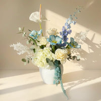 أريج المحيط: ترتيب زهور أنيق في وعاء أبيض