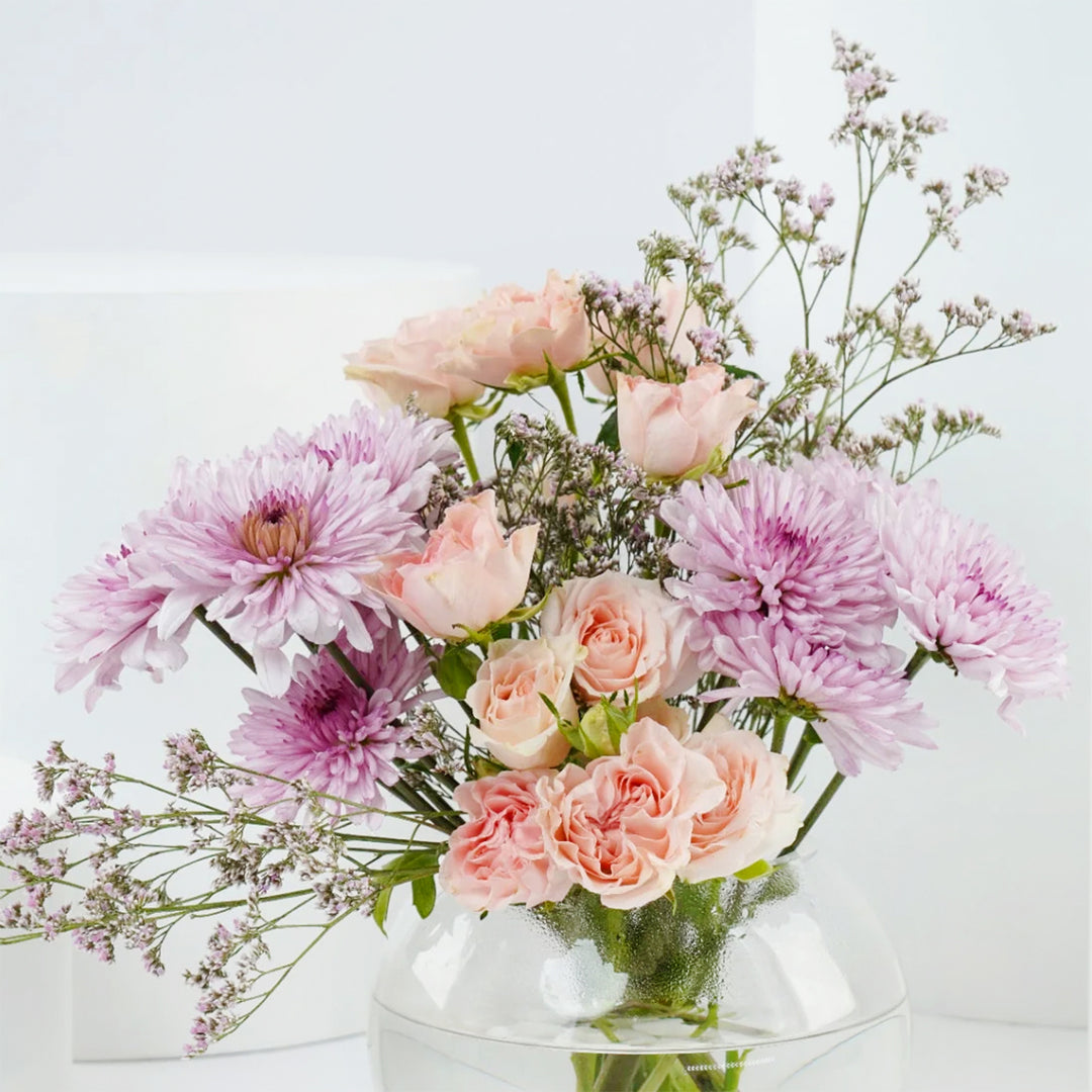 Radiant Femme Sphere: Elegant Floral Arrangement in Fish Bowl