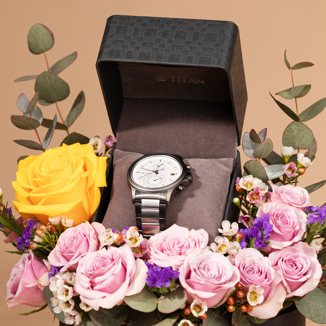 Titan Quartz Analog Men's Watch with Silver Dial and Stainless Steel Strap, Presented in an Elegant Floral Arrangement