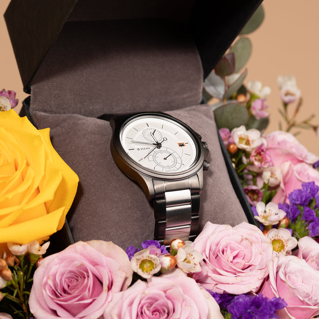 Titan Quartz Analog Men's Watch with Silver Dial and Stainless Steel Strap, Presented in an Elegant Floral Arrangement