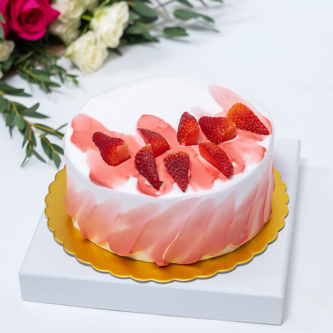 باقة زهور يدوية رائعة ملفوفة بالخيش مع كعكة الشوكولاتة المزينة بالفراولة